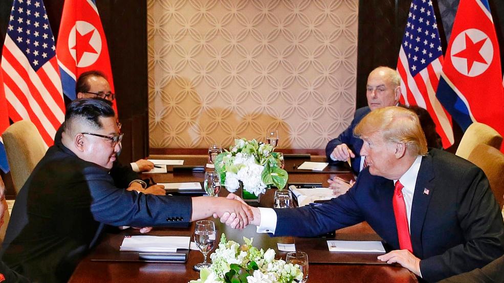 Trump Kim Summit Day in Photos Trump Un summit handshake table AP832.jpg